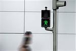 People crossing the road in motion effect with the green safe signal.