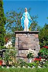 statue of the Virgin Mary mother of Jesus atop a church in village, poland