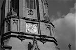 Black and white image of the main tower of Christ Church, Oxford, UK, named after the bell "Old Tom" it hauses. Christ Church is one of the colleges of Oxford Univeristy and at the same time the Cathedral church of the diocese of Oxford.