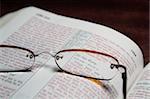 Reading glasses on an open bible.