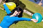 Beautiful teen handling balloons