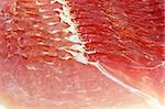Detail from slices of smoked ham as background