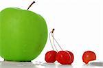 green apple and some cherries, close-up, white background