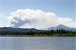 A cloud of smoke rises from the Lake George forest fire in Central Oregon in 2006.  The plume of smoke is rising over Mt. Washington in the Oregon Cascades.