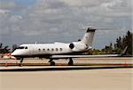 Small charter airplane parked on runway and awaiting passengers