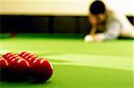 snooker player hitting a ball, shallow depth of field