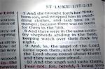 Saint Luke's account in the bible of the birth of Jesus Christ. A beam of light highlights the verses.