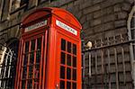 Classic bright red British telephone box set against ornate building