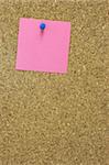 Colorful blank post it note affixed to the corkboard.