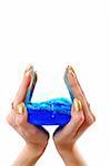 hands holding chemical flask with blue liquid, white background