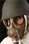 woman in gas mask and helmet on black background