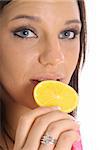 model eating an orange slice upclose