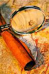 Magnifying glass, scroll, and map with antique look