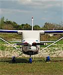 Front view of Cessna airplane parked at remote airport