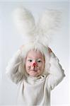 Child in a white downy bunny costume.