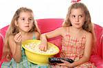 children eating popcorn watching tv