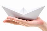 Woman holding a folded paper boat. Isolated on a white background.