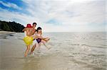 3 friends playing with sea water at the beach