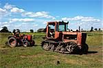 Two old tractors on the meadow at dinner-time