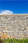 Ancient rustic stone wall beautifully preserved in a shiny day