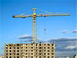 Hoisting crane on sunny weather