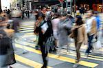 Blurred people crossing street in the city