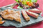 grilled beef steak with green salad and cherry tomatoes