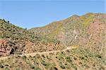 Dirt road curving through desert mountains, Apache Trail, northeast of Phoenix, Arizona