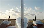 twin engined airplane on runway at sunset