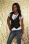 Dark skinned beauty in a pinstripe vest and jeans