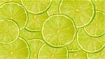 Background of fresh juicy lime slices on a large heap