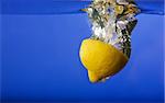 A lemon with a blue background in water