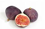 Two and a half ripe figs on bright background