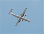 Light turboprop airplane passing overhead