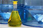 Erlenmeyer flask with yellow liquid in chemistry lab (blue background)