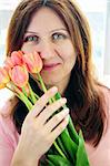 Smiling mature woman holding bouquet of flowers