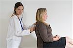 Older female patient being examined by a younger female doctor