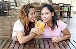 Pretty Asian girls having a drink at a cafe.