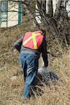 A man working for the town, doing spring clean-up