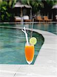 Tropical cocktail next to a swimming pool.