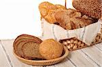 Assorted bread in basket and palte, isolated on white background