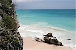 The rocky beach jagged, but beautiful turquoise sea of Tulum in Mexico.