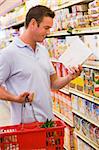Man checking food labelling on supermarket products