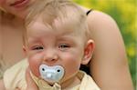 Young cute boy with soother in his mouth