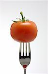 a tomato on a fork