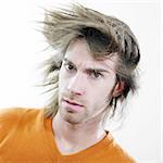 A portrait of a young man looking serious with a strange hairstyle.