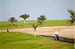 Golfer walking at path to next hole