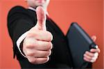 Businessman with laptop, holding thumb up
