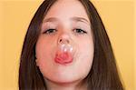 Girl making a bubble from a chewing gum