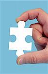 Hand and puzzle, isolated on blue background